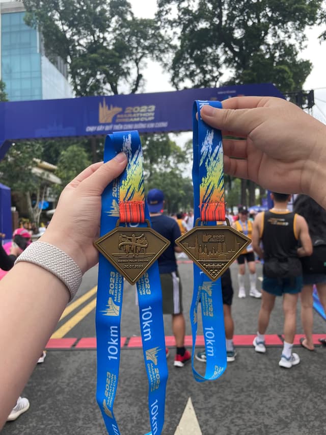 Hieu and his wife at a 10K race finish line