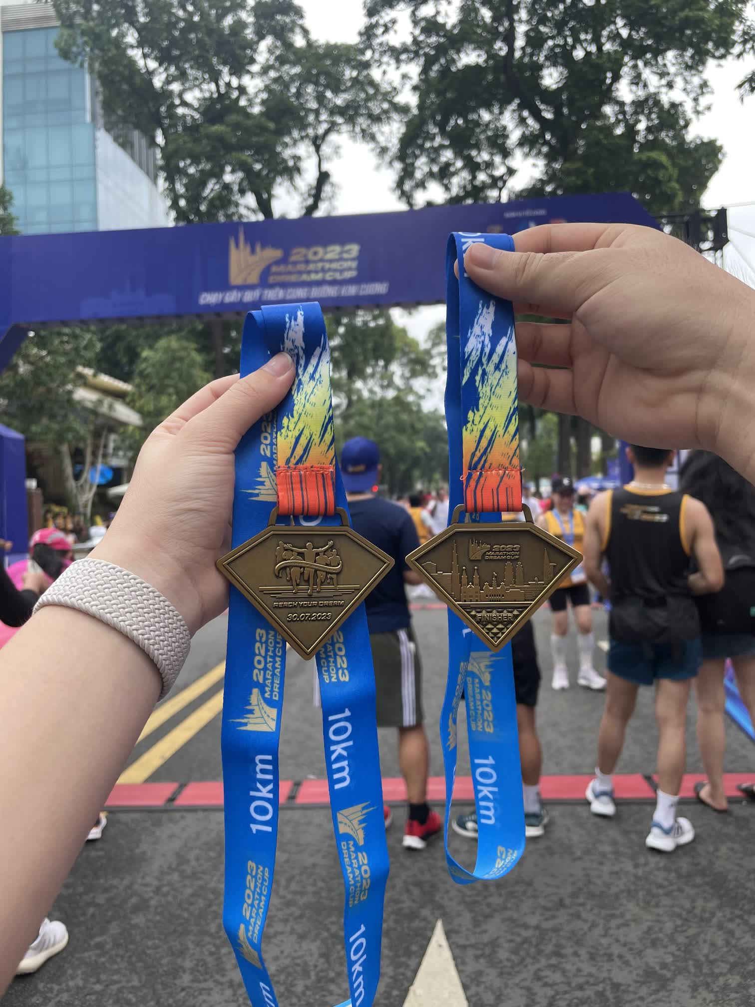 Hieu and his wife at a 10K race finish line